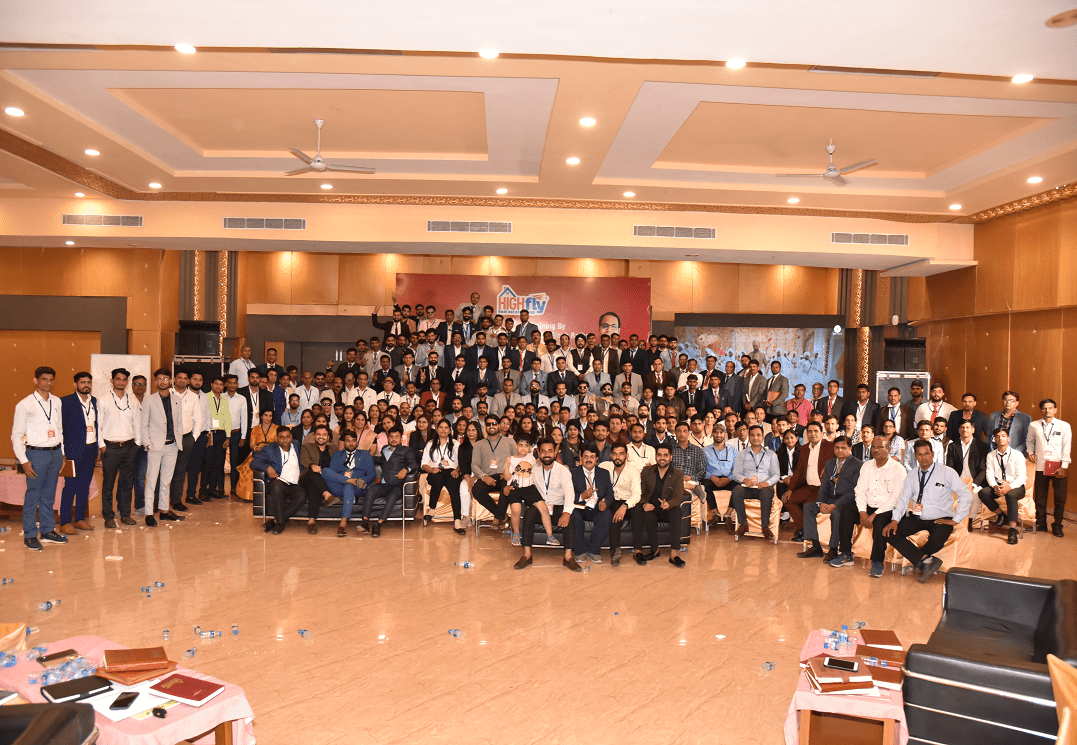 A group of High Fly real estate team members posing for a photo in a spacious room in Jaipur, Rajasthan
